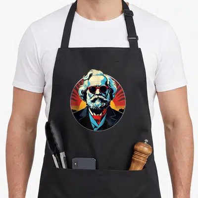 Tablier de cuisine noir avec portrait Karl Marx en Pop Art lunettes rouges barbe blanche fond rayonnant rouge et jaune