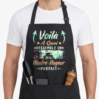 Tablier de cuisine noir avec inscription Voilà À Quoi Ressemble Un Maître-Nageur Parfait et illustration de station balnéaire.