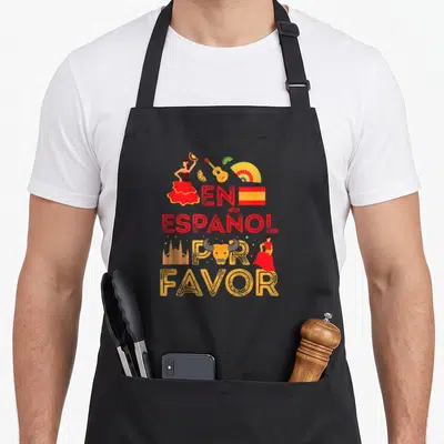Tablier de cuisine noir avec inscription en español por favor et illustrations thématiques espagnoles colorées.