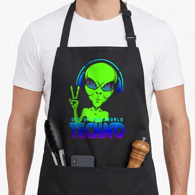 Tablier de cuisine noir avec un alien vert portant des écouteurs bleus et faisant un signe de la paix sous le mot Techno.