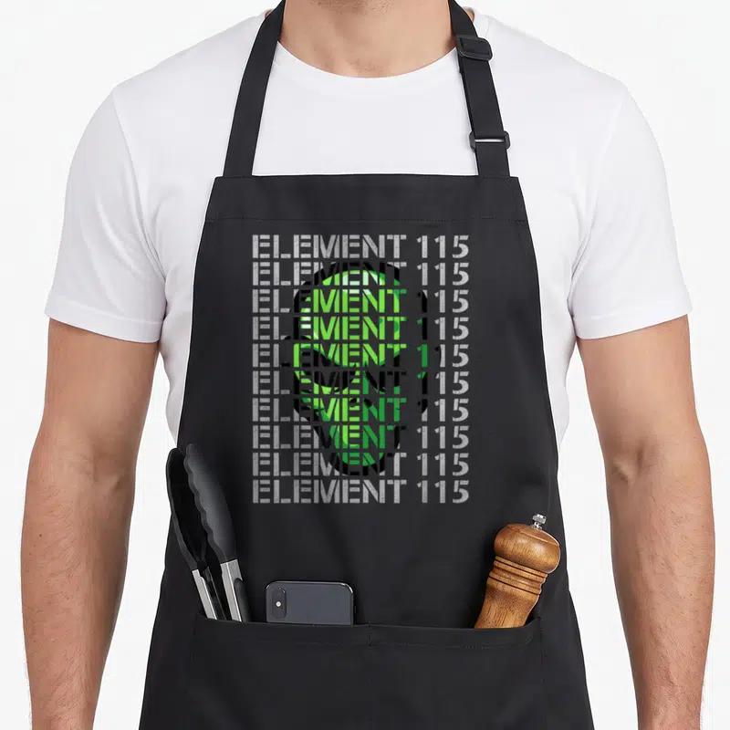 Tablier de cuisine noir avec motif typographique Element 115 et silhouette d'alien vert superposée.