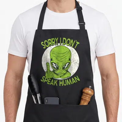 Tablier de cuisine noir avec un alien vert levant le majeur et le texte sorry i don t speak human.