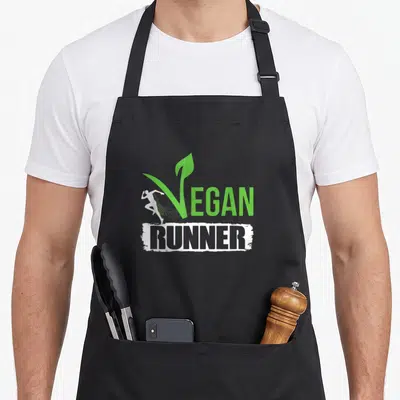 Tablier de cuisine noir avec logo vert et blanc Vegan Runner et silhouette de sportif en mouvement.