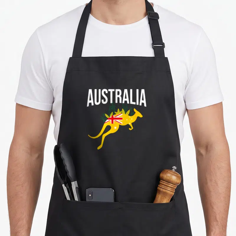 Tablier de cuisine noir avec un kangourou jaune et le mot Australia imprimé en blanc.