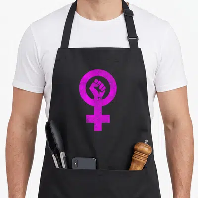 Tablier de cuisine noir avec le symbole féminin en rose vif contenant un poing levé au centre.