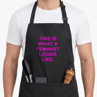 Tablier de cuisine noir avec inscription rose vif This Is What a Feminist Looks Like.