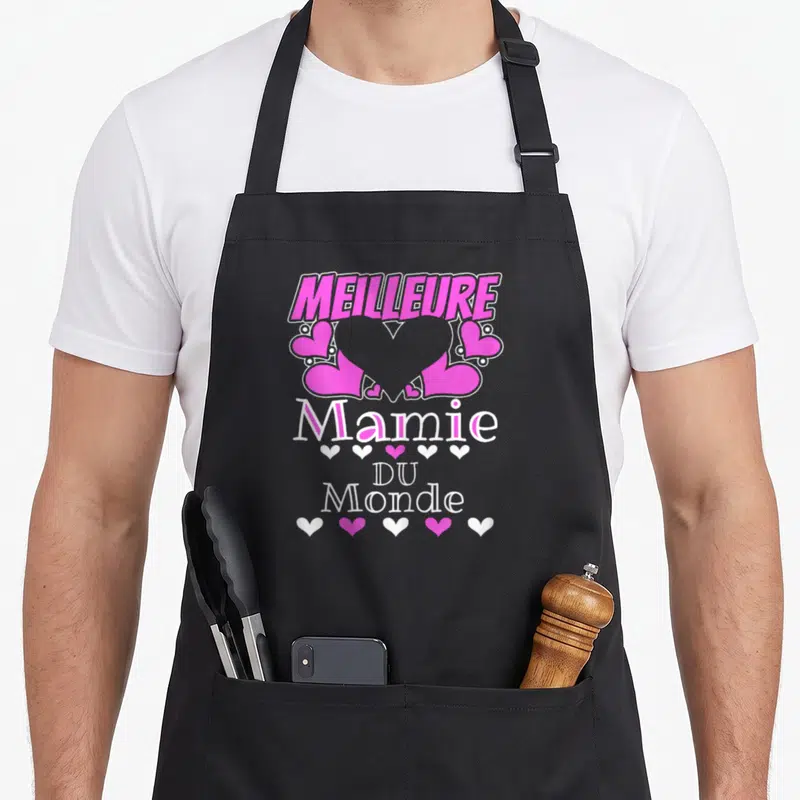 Tablier de cuisine noir avec inscription Meilleure Mamie Du Monde et motifs de cœurs roses et blancs.