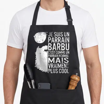 Tablier de cuisine noir avec illustration de barbe et texte blanc humoristique pour parrain.