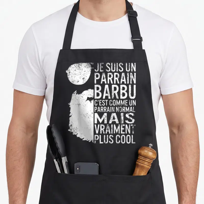 Tablier de cuisine noir avec illustration de barbe et texte blanc humoristique pour parrain.