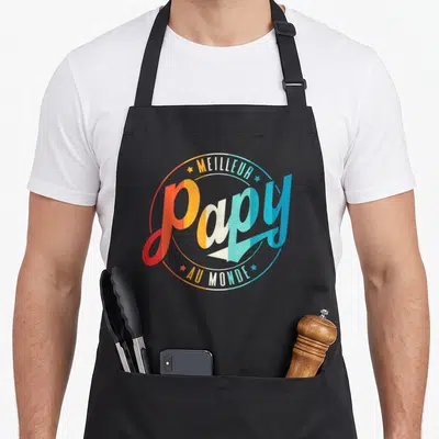 Tablier de cuisine noir avec l'inscription Meilleur Papy au Monde en lettres colorées et style rétro.