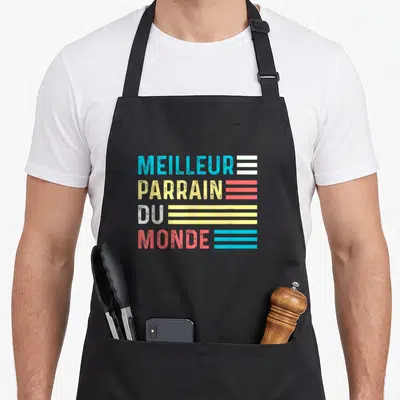 Tablier de cuisine noir avec l'inscription Meilleur Parrain du Monde en lettres colorées et lignes horizontales rétro.