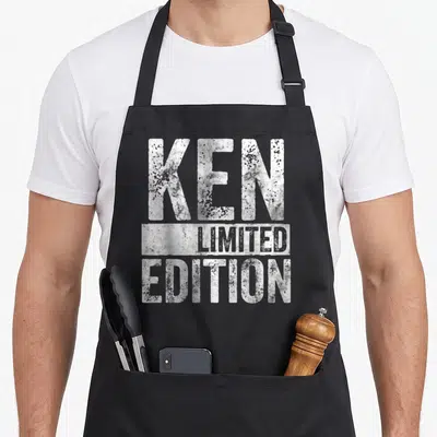 Tablier de cuisine noir avec l'inscription KEN LIMITED EDITION en lettres blanches texturées style graffiti.