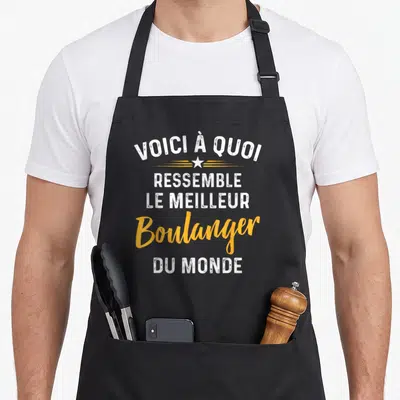 Tablier de cuisine noir avec inscription Voici à quoi ressemble le meilleur boulanger du monde en blanc et orange.