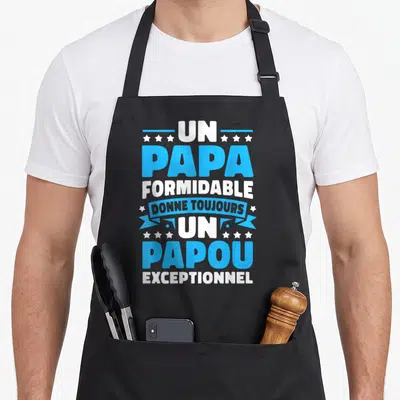 Tablier de cuisine noir avec inscription Un Papa Formidable Donne Toujours Un Papou Exceptionnel en bleu et blanc entouré d'étoiles.