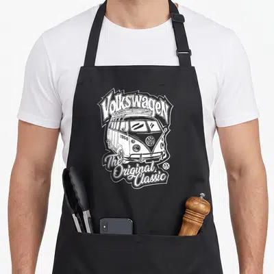 Tablier de cuisine noir avec illustration blanche d'un camping-car Volkswagen vintage et du texte The Original Classic.