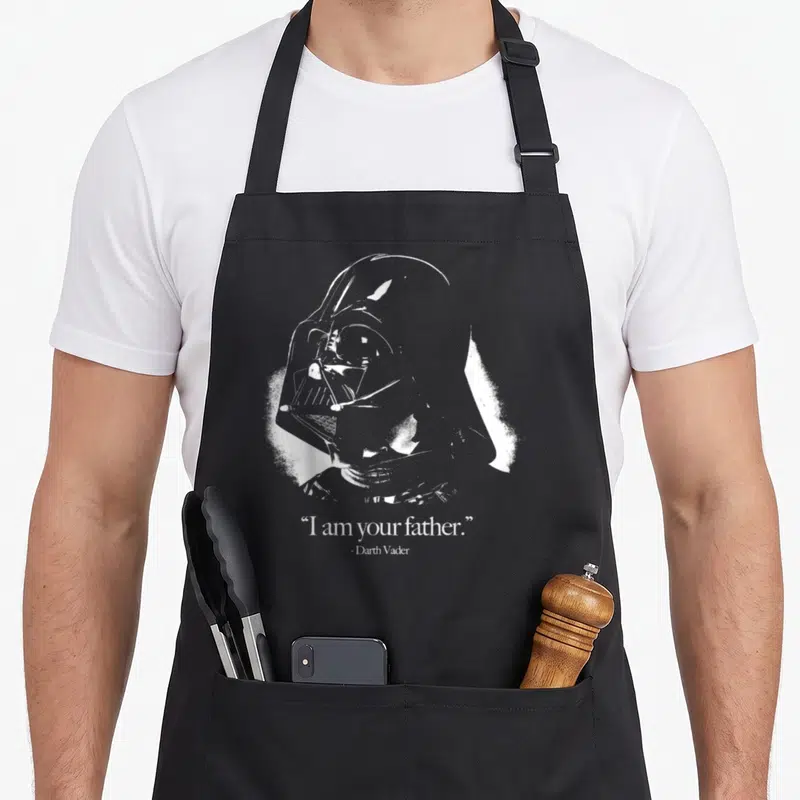 Tablier de cuisine noir avec portrait blanc de Darth Vader et la citation I am your father en bas du motif imprimé.