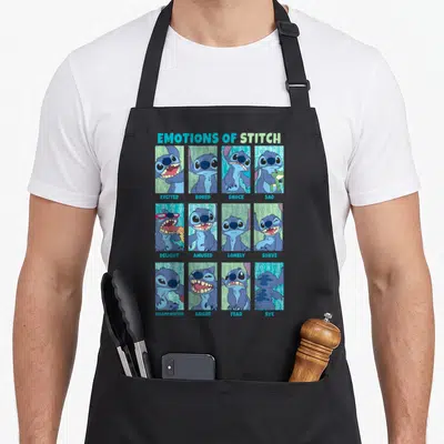Tablier de cuisine noir avec douze vignettes représentant les différentes émotions du personnage Stitch en bleu et turquoise.