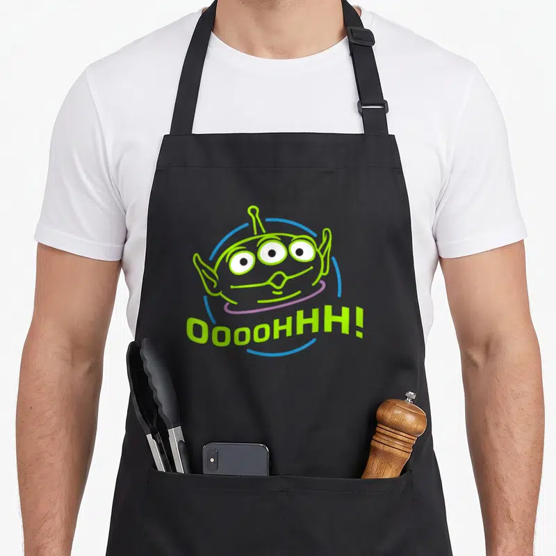 Tablier de cuisine noir avec illustration de l'alien vert et le texte Oooohhh en vert fluo.