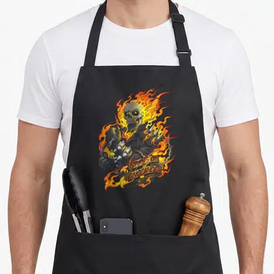 Tablier de cuisine noir avec un crâne enflammé et l'inscription Spirit of Vengeance en lettres dorées stylisées.