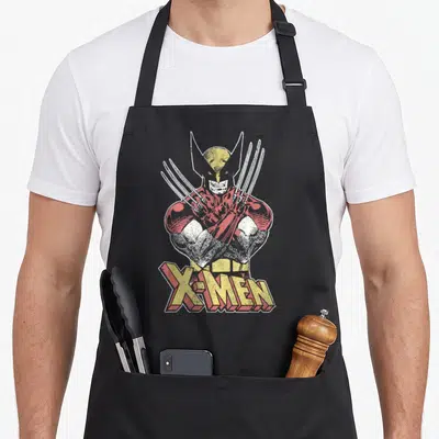 Tablier de cuisine noir avec illustration vintage de Wolverine aux griffes déployées et le logo X-Men en lettres jaunes et rouges.