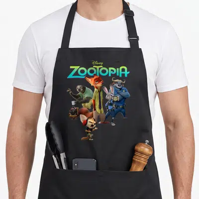 Tablier de cuisine noir avec le logo Zootopie et le groupe des personnages animés imprimés au centre.