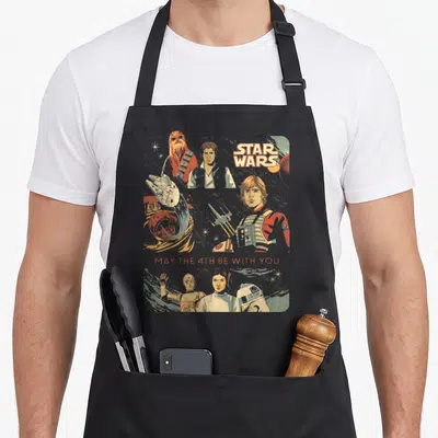 Tablier de cuisine noir avec illustration vintage Star Wars May the 4th Be with You et personnages classiques.