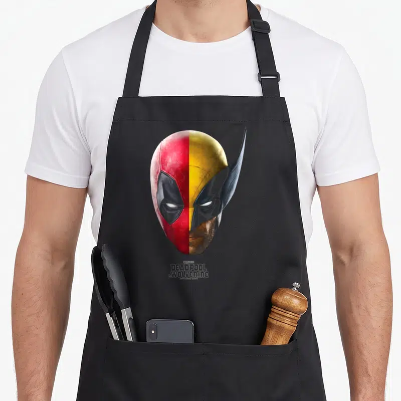 Tablier de cuisine noir avec portrait divisé de Deadpool et Wolverine en deux tons distincts.