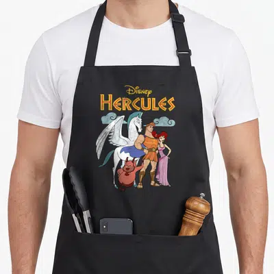 Tablier de cuisine noir avec illustration d'Hercules, Pégase, Phil et Mégara sous le logo Disney Hercules.