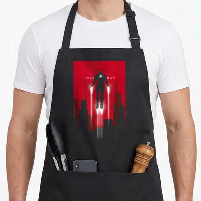 Tablier de cuisine noir avec silhouette d'Iron Man en vol sur fond rouge et texte IRON MAN