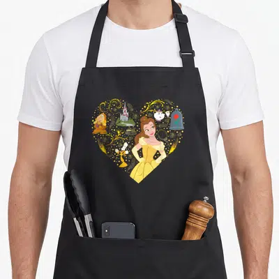 Tablier de cuisine noir avec un grand cœur jaune contenant Belle et les personnages de l'animal.