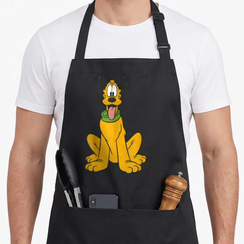 Tablier de cuisine noir avec illustration colorée de Pluto assis la langue sortie