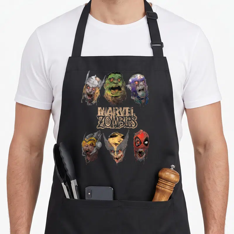 Tablier de cuisine noir avec six têtes de super-héros zombies et le logo Marvel Zombies au centre.