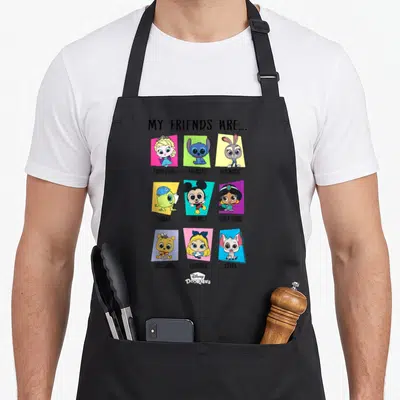 Tablier de cuisine noir avec illustration My Friends Are montrant neuf personnages Disney Pixar Doorables sur fonds colorés.
