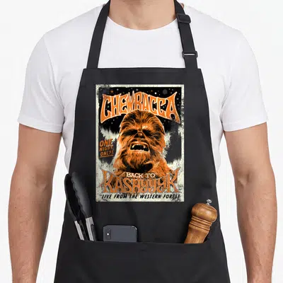 Tablier de cuisine noir avec illustration vintage de Chewbacca et texte orange Back to Kashyyyk One Night Only.