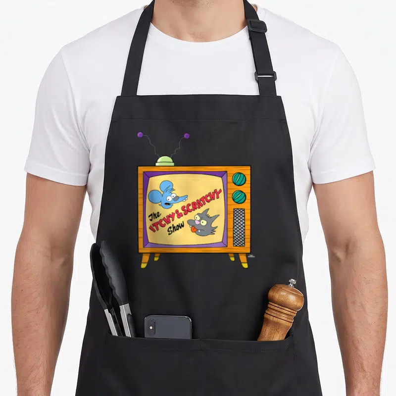 Tablier de cuisine noir avec une illustration de télévision rétro affichant un chat et un mouse en animation vintage.