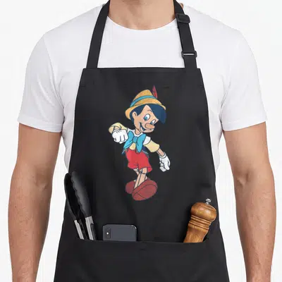 Tablier de cuisine noir avec illustration vintage de Pinocchio en tenue classique souriante.