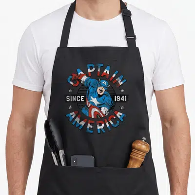Tablier de cuisine noir avec illustration vintage Captain America Since 1941 et bouclier étoilé.