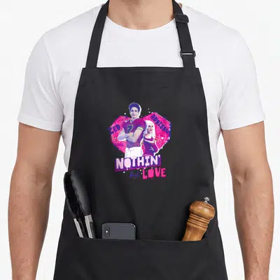 Tablier de cuisine noir avec illustration de Zed et Addison sur fond rose et texte Nothin But Love en style graffiti.