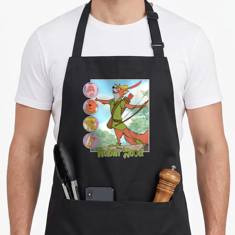 Tablier de cuisine noir avec illustration colorée de Robin Hood et personnages Disney en vignettes latérales.