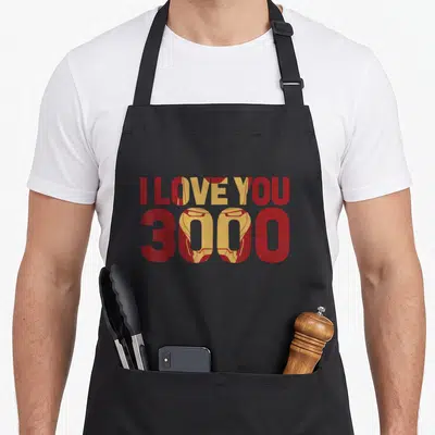 Tablier de cuisine noir avec le texte I Love You 3000 intégrant le masque d'Iron Man en rouge et or.