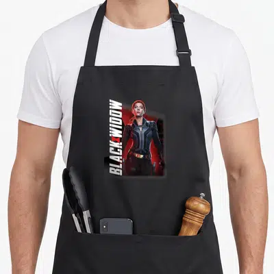 Tablier de cuisine noir avec portrait de Black Widow et texte vertical blanc sur fond rouge sombre.