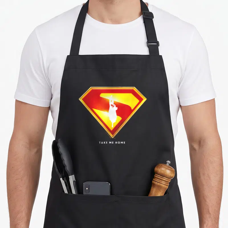 Tablier de cuisine noir avec un logo Superman Take Me Home rouge jaune et blanc