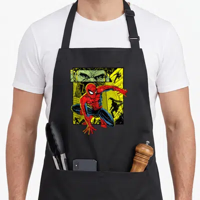 Tablier de cuisine noir avec une illustration colorée de Spider-Man et un regard vert intense en haut à gauche.