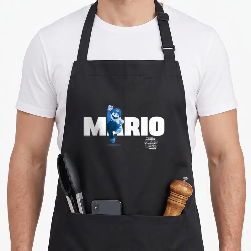 Tablier de cuisine noir avec Mario en saut et le texte MARIO blanc imprimé sur le devant.