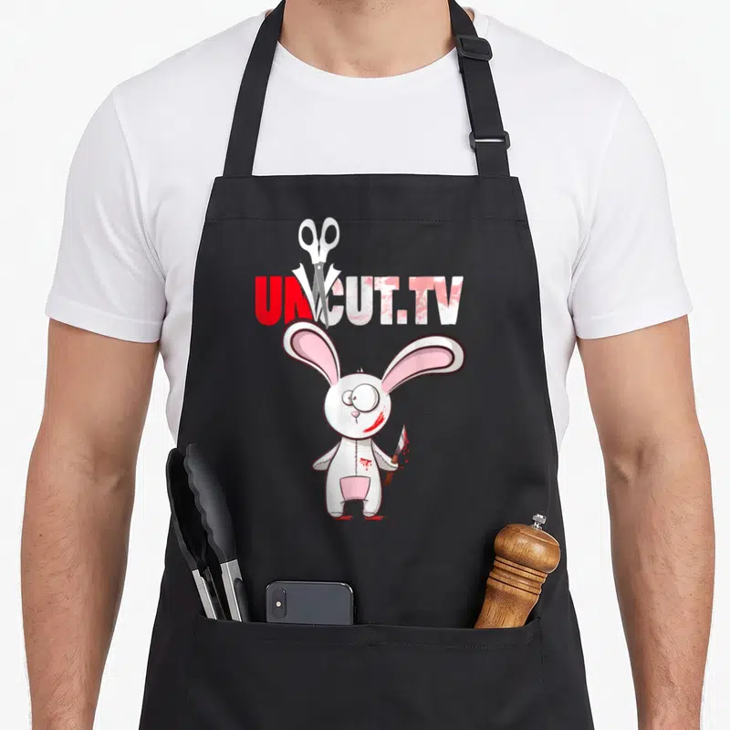 Tablier de cuisine noir avec lapin blanc tenant un couteau et le logo UnCut.TV en rouge et blanc.