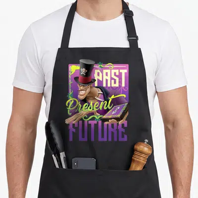 Tablier de cuisine noir avec illustration du personnage Facilier portant un chapeau haut de forme et tenant des cartes à jouer.