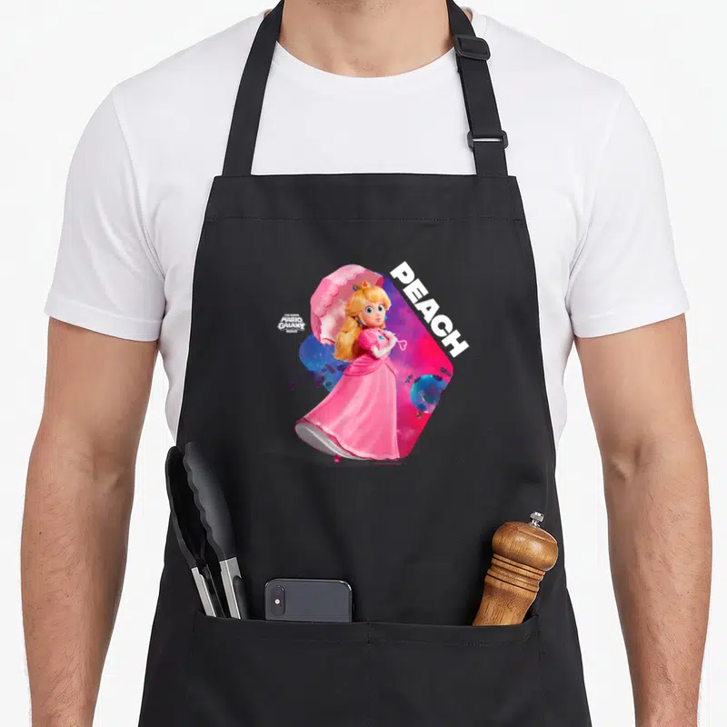 Tablier de cuisine noir avec une illustration de la Princesse Peach tenant un parapluie rose sur fond d'univers spatial coloré.
