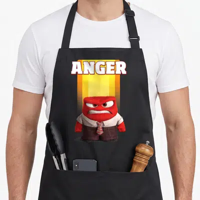 Tablier de cuisine noir avec le personnage rouge Anger et l'inscription ANGER en lettres blanches.