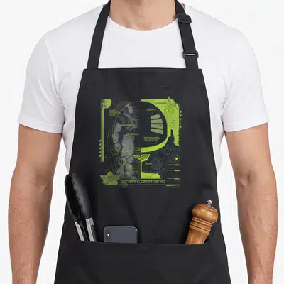 Tablier de cuisine noir avec schéma technique Space Ranger vert fluo et logo Star Command en bas à gauche.