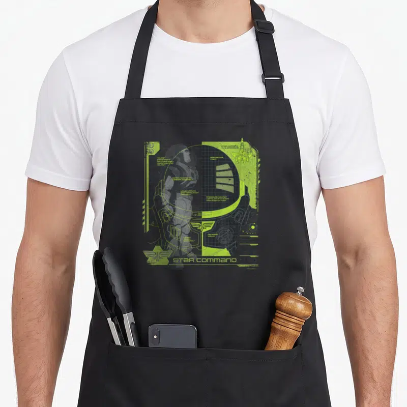 Tablier de cuisine noir avec schéma technique Space Ranger vert fluo et logo Star Command en bas à gauche.